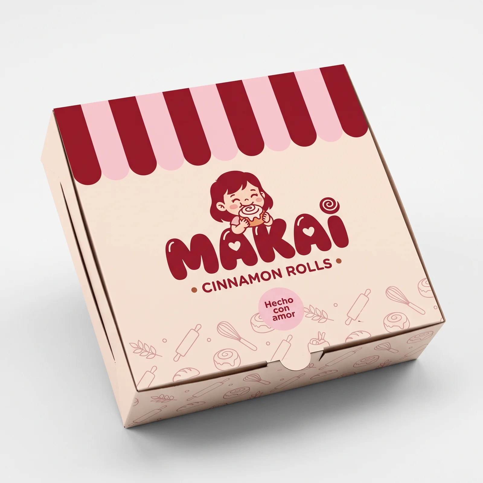 A Makai cinnamon roll box with burgundy stripes and a playful illustrated mascot on a cream background.