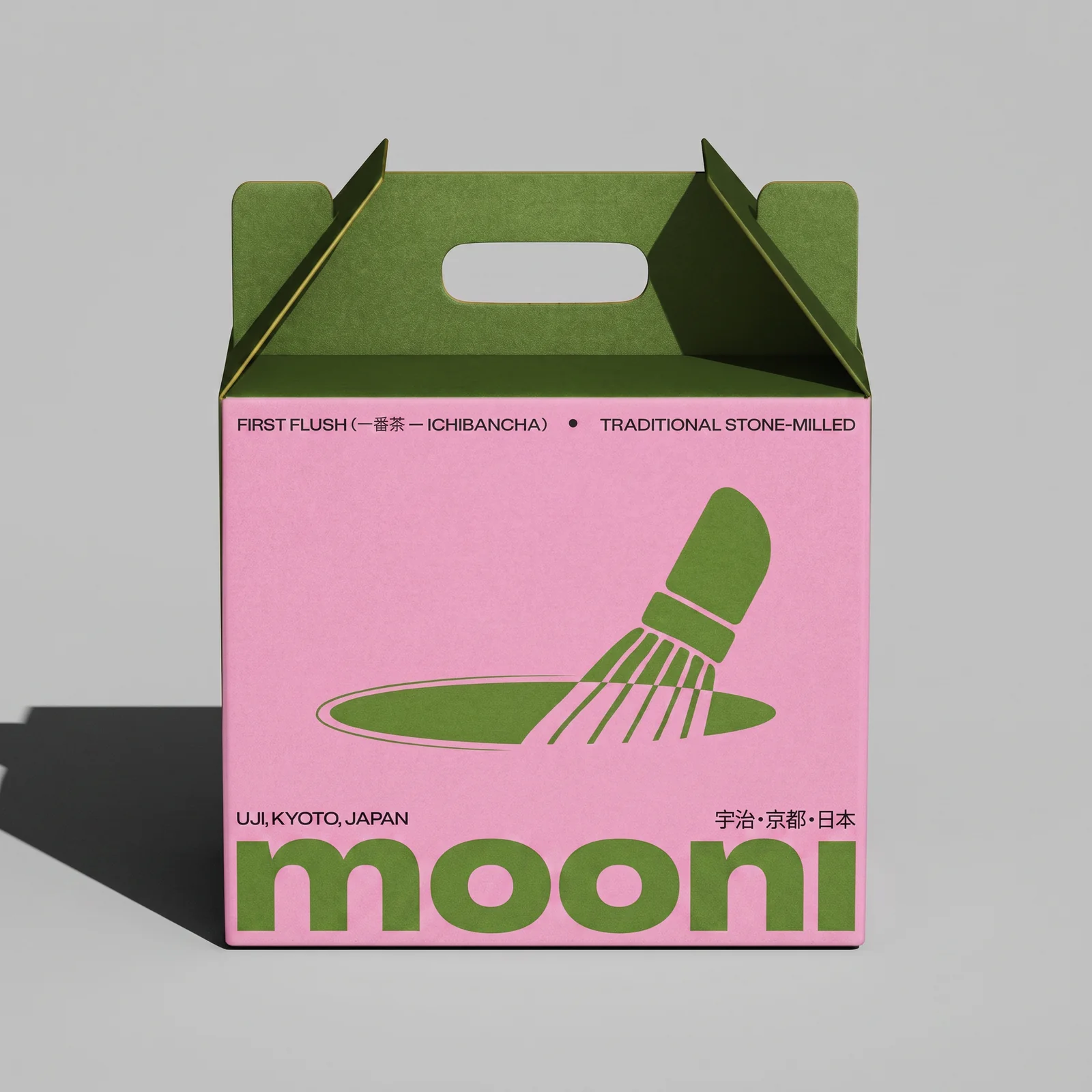 A pink MOONI takeaway box with green handles, bold green lettering and a matcha whisk illustration.